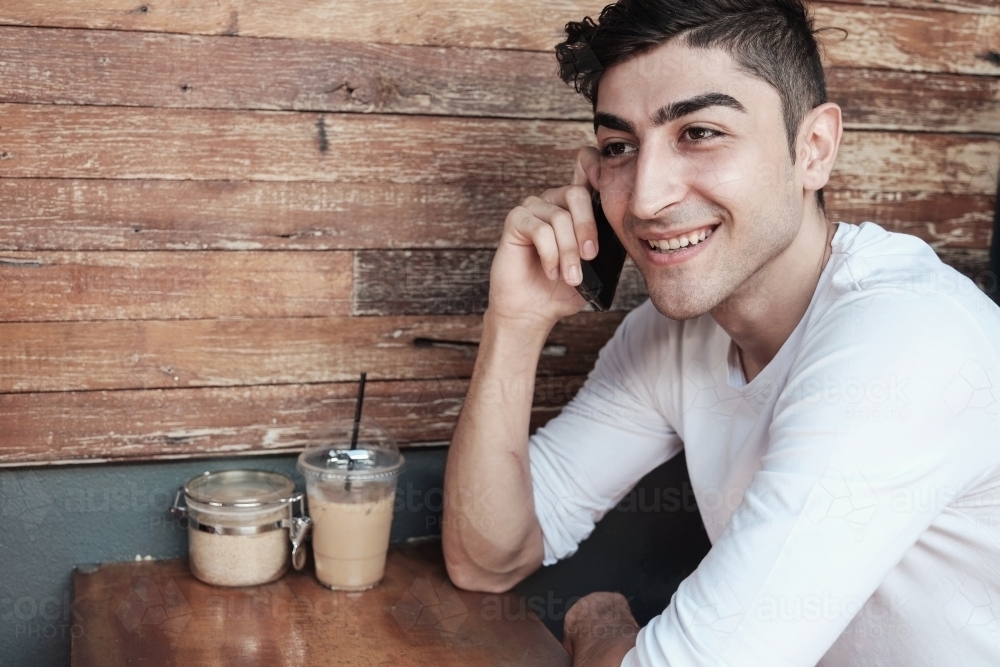 multicultural young adult man on the phone - Australian Stock Image