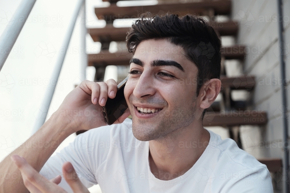 multicultural young adult man on the phone - Australian Stock Image