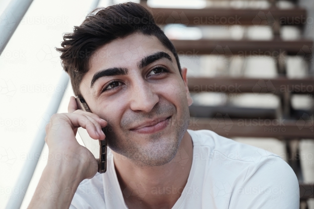 multicultural young adult man on the phone - Australian Stock Image