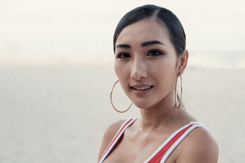 Multicultural young adult woman on the beach - Australian Stock Image