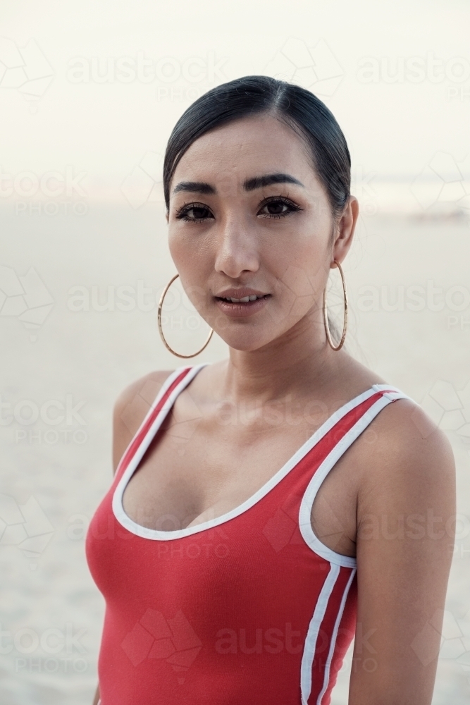 Multicultural young adult woman on the beach - Australian Stock Image
