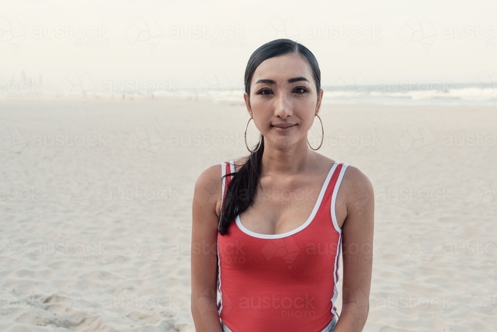 Multicultural young adult woman on the beach - Australian Stock Image