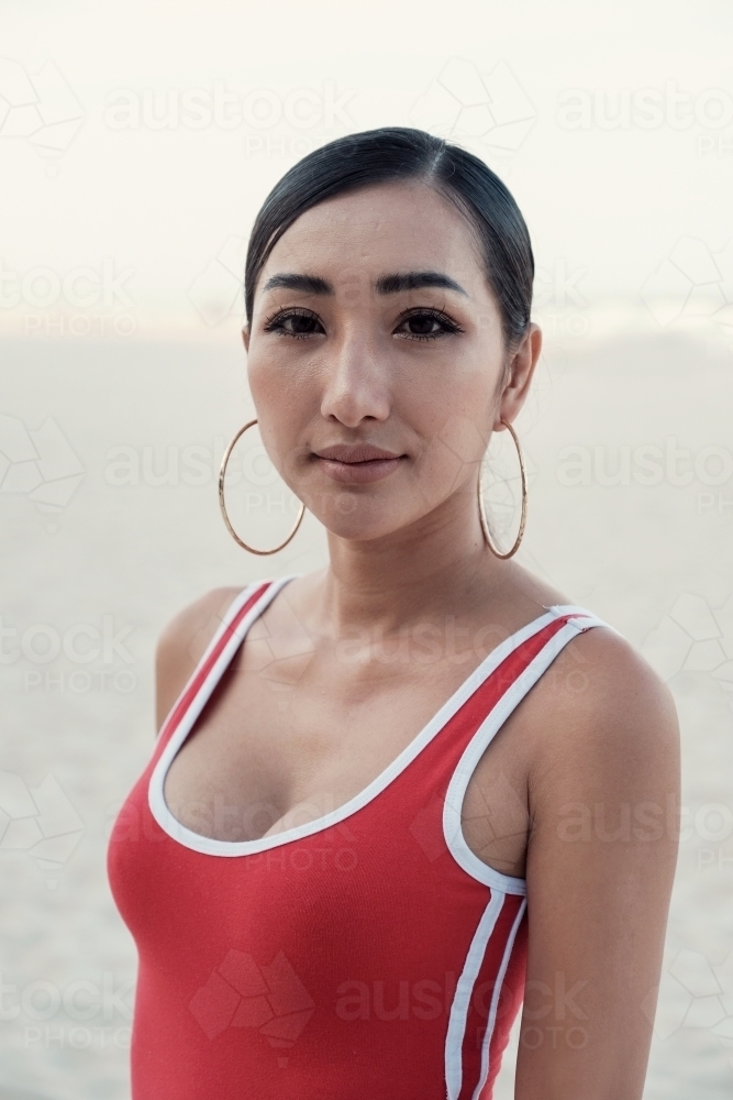Multicultural young adult woman on the beach - Australian Stock Image