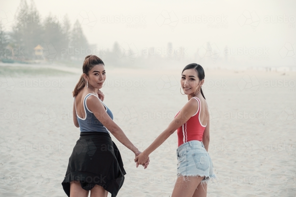 Multicultural young adult women on the beach - Australian Stock Image