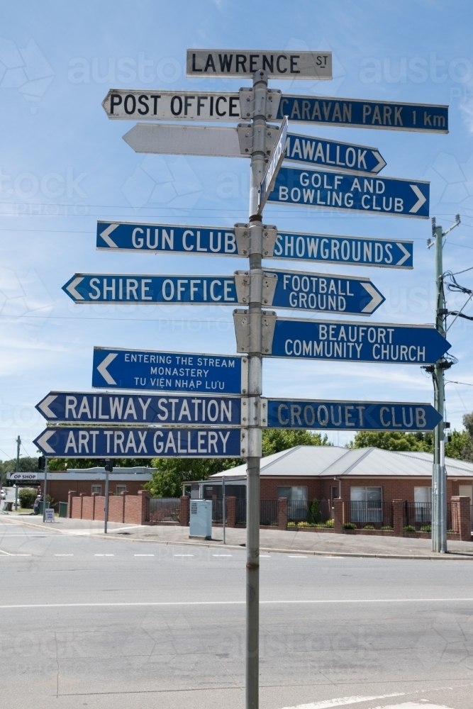 Image of Multiple street direction signs in country town - Austockphoto