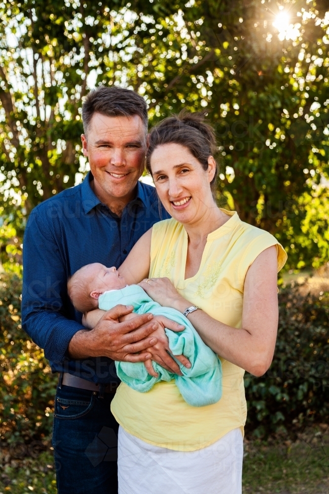 Mum and dad with their newborn daughter - Australian Stock Image