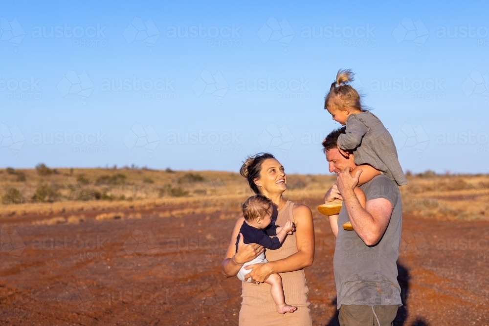 mum and dad with two little kids outdoors in the outback - Australian Stock Image