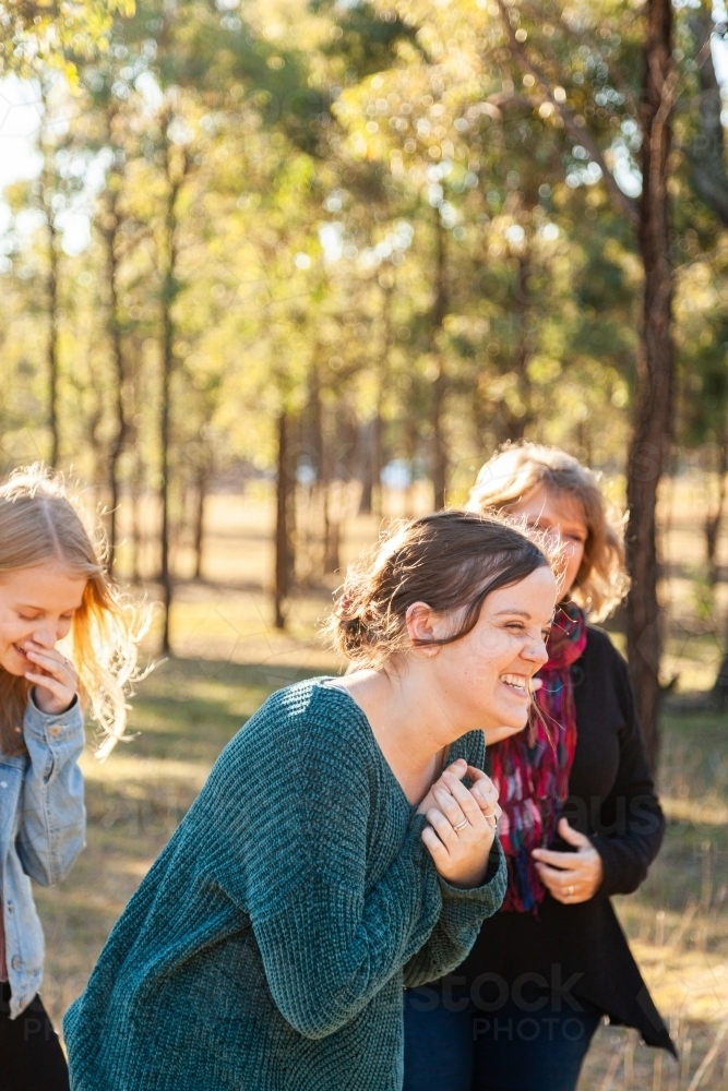 Mum and daughters laughing together - Australian Stock Image