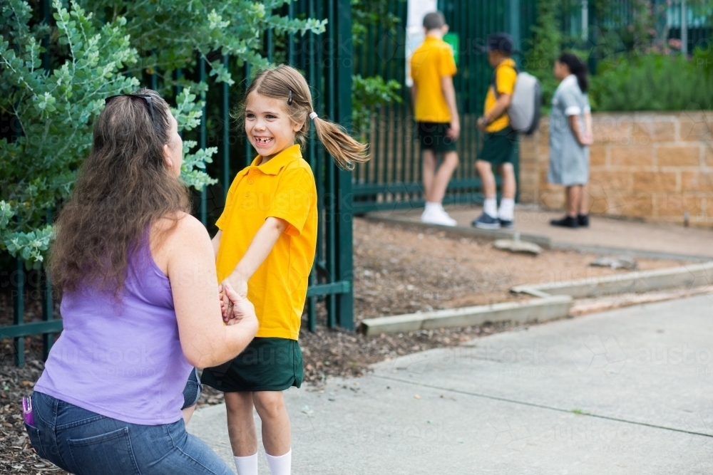 Mum dropping her child off at school saying goodbye - Australian Stock Image