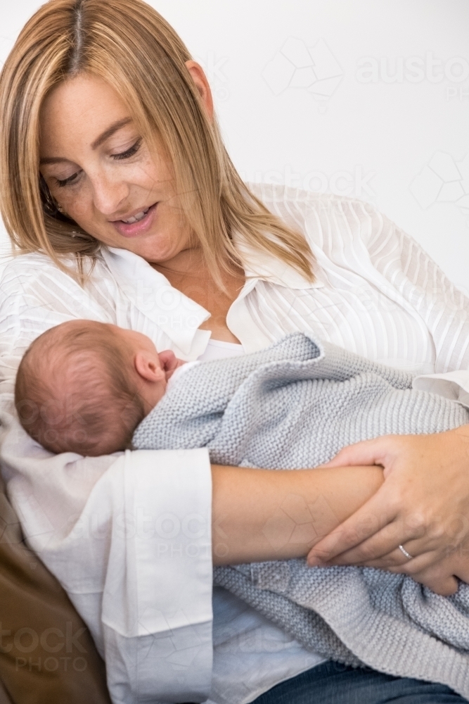 Mum looking at newborn. - Australian Stock Image