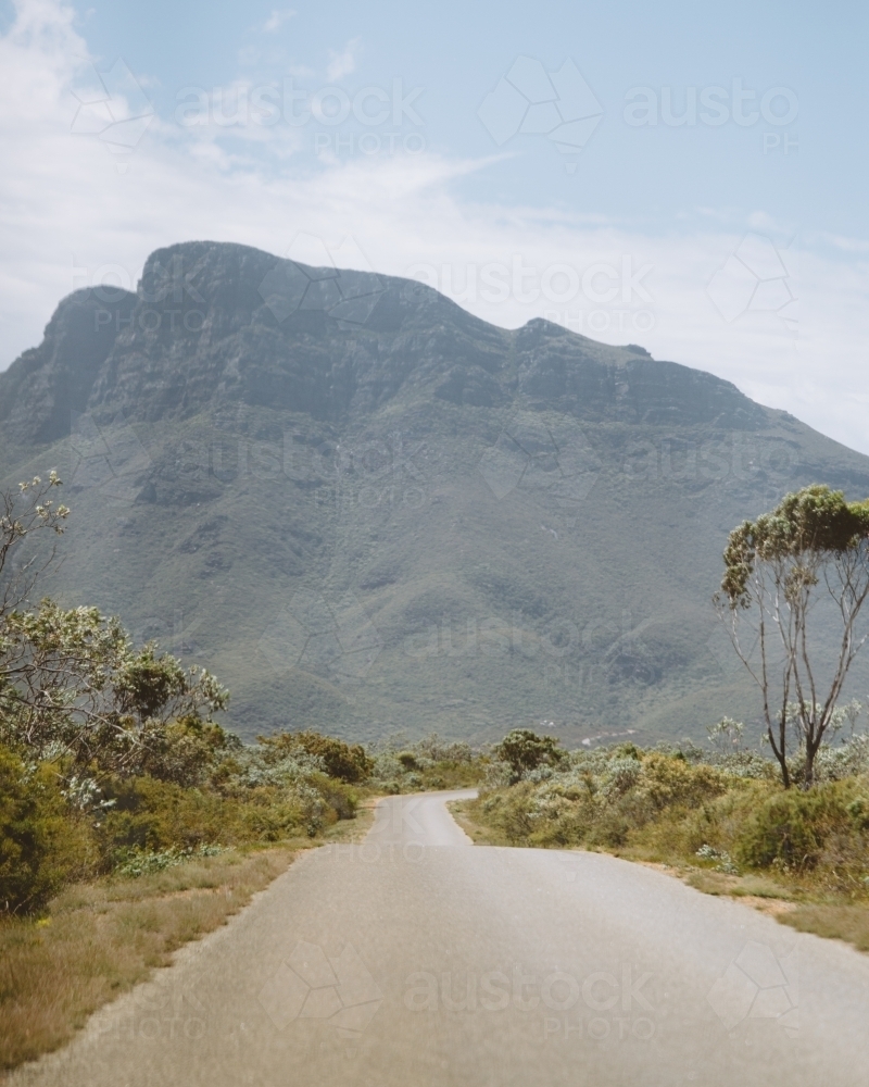 Narrow road leading to a mountain - Australian Stock Image