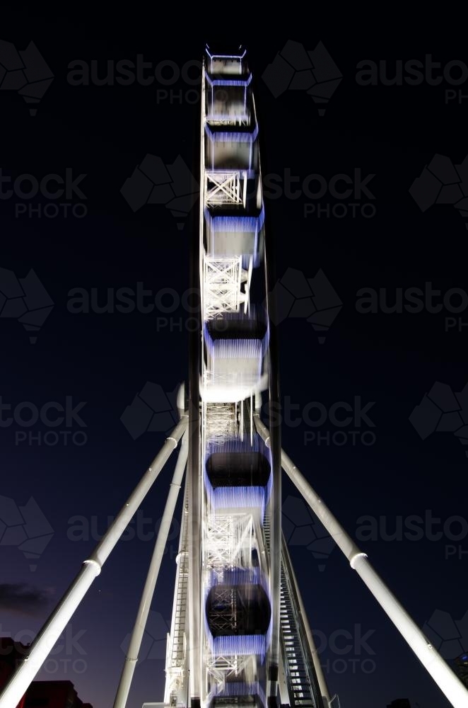 Narrow view of Brisbane Wheel lit up at night with movement blur - Australian Stock Image