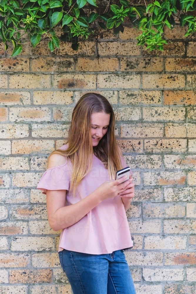 natural teen girl with mobile phone - Australian Stock Image