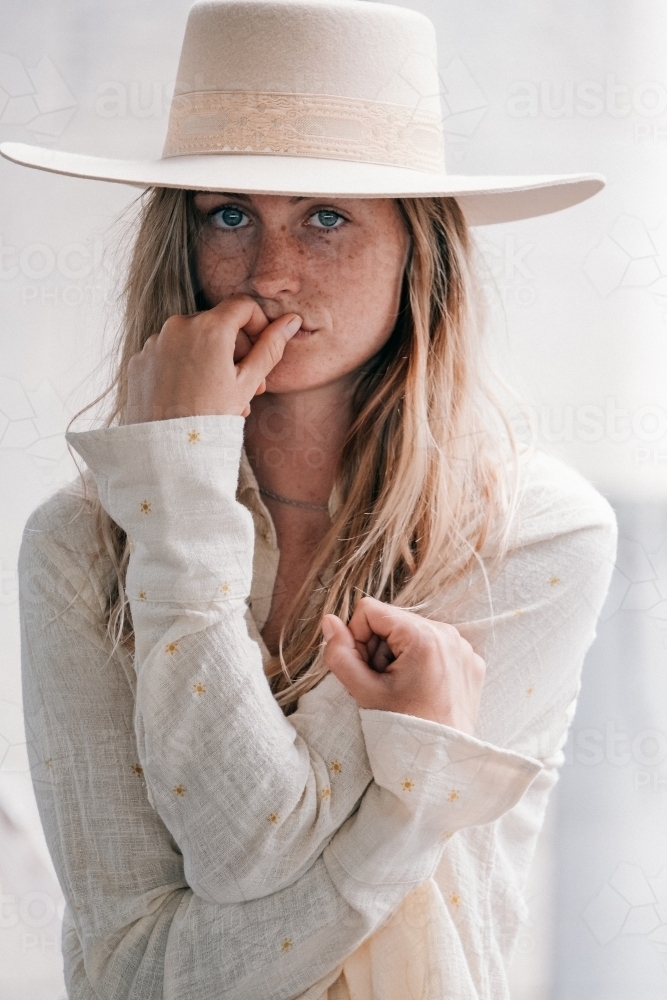 Natural tones and a young women wearing a hat. - Australian Stock Image