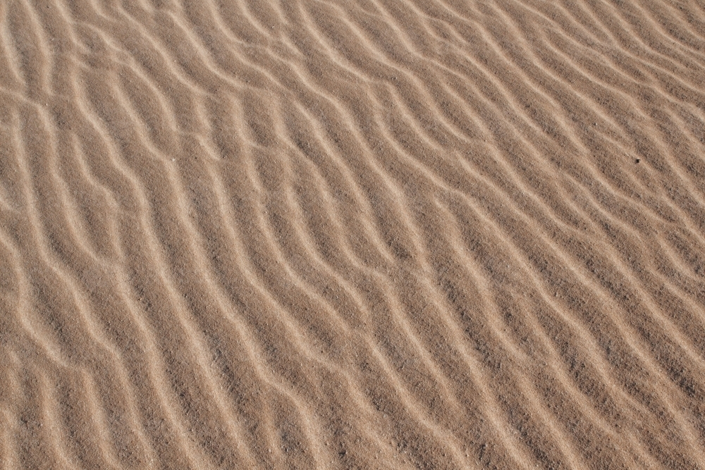 Nature's Canvas: Intricate Patterns in Coastal Sand Texture - Australian Stock Image