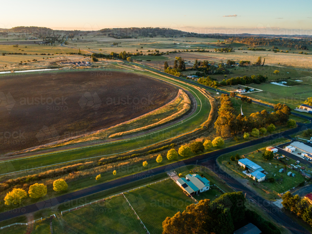 neat racetrack racecourse with tree lined road in rural landscape in NSW Australia - Australian Stock Image