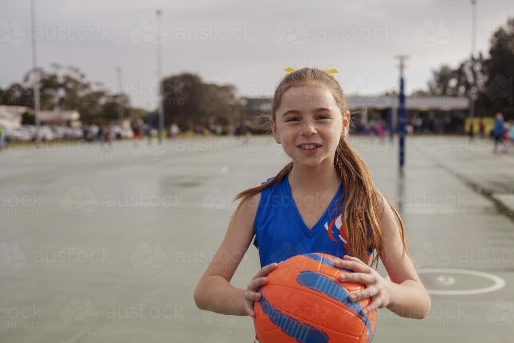 Netball girl holding ball pre game - Australian Stock Image