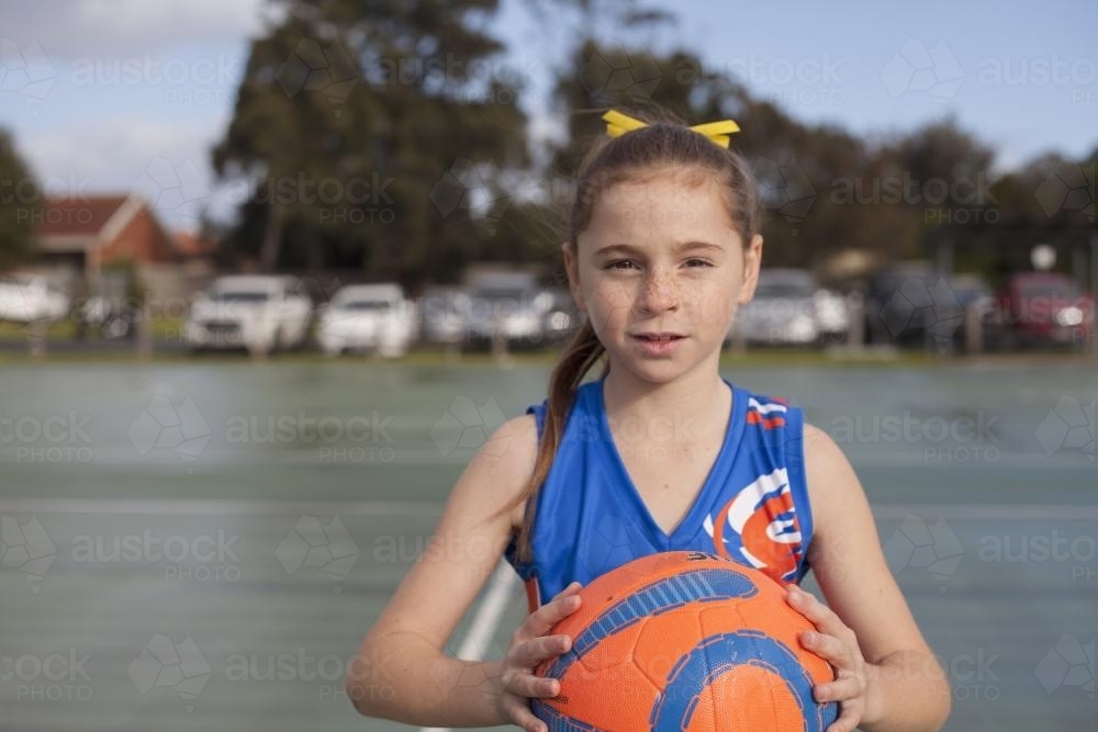 Netball girl holding ball pre game - Australian Stock Image