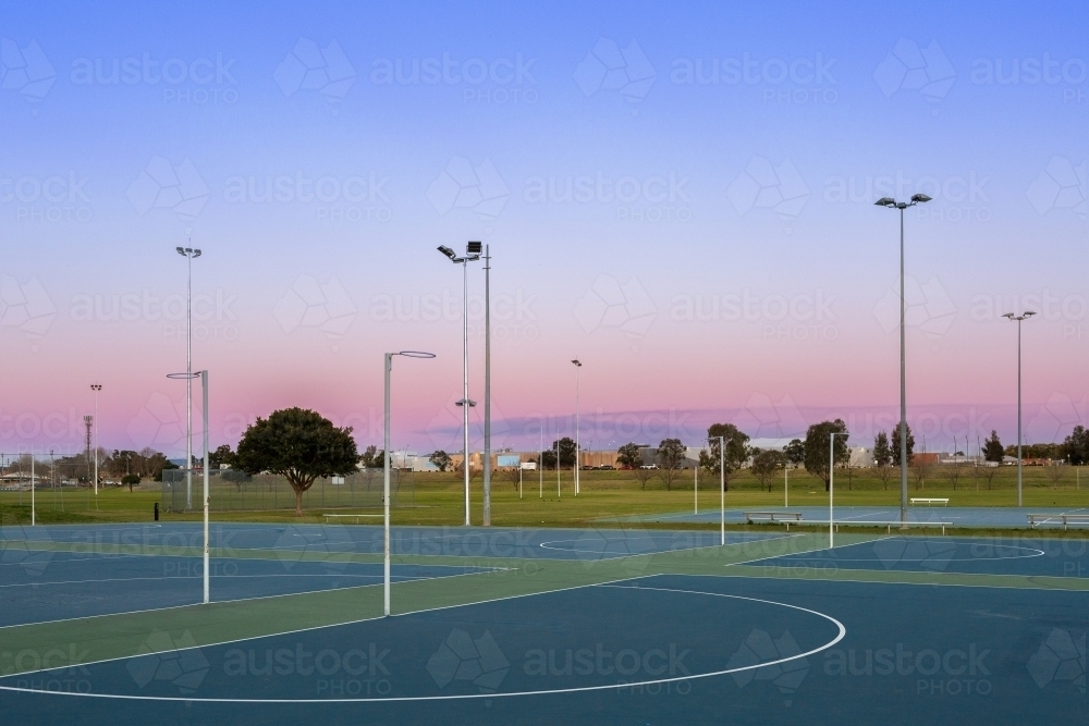 Image of Netball hoop at empty community sports ground in dusk light ...