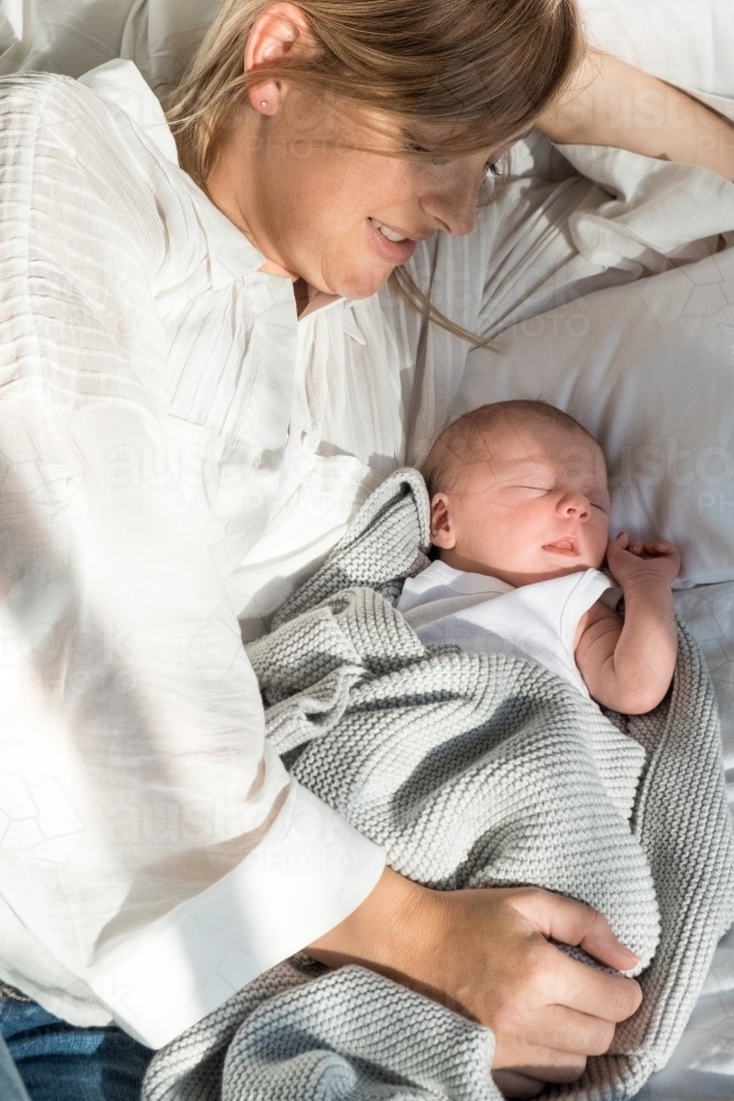 New born baby and mum lying together. - Australian Stock Image
