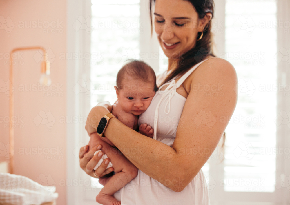 Newborn baby girl resting on mother's chest - Australian Stock Image