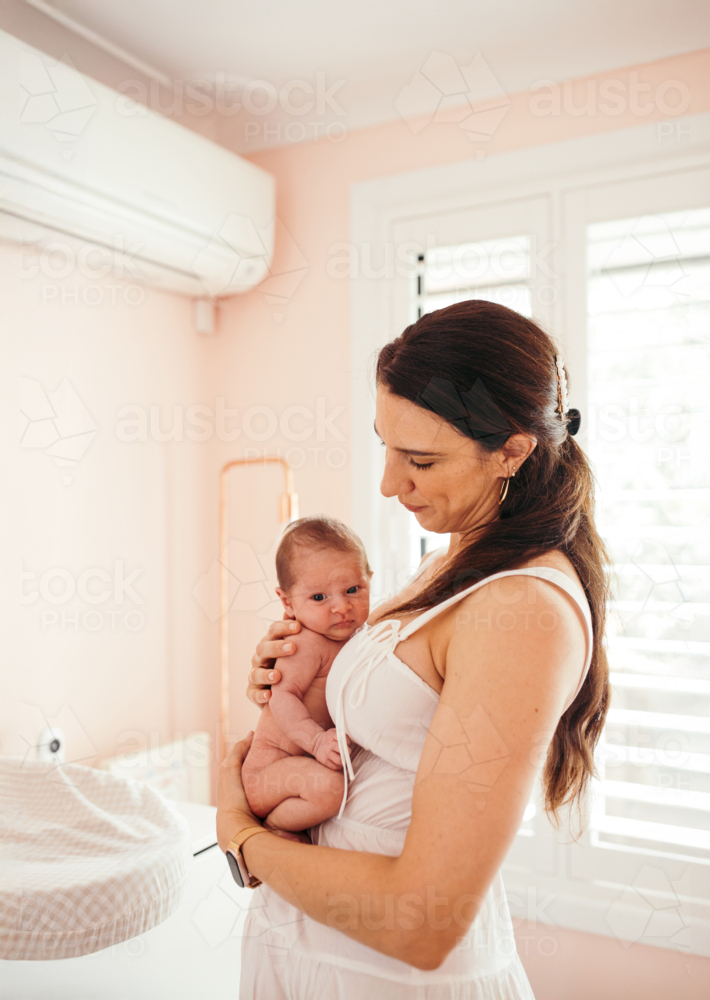 Newborn baby girl resting on mother's chest - Australian Stock Image