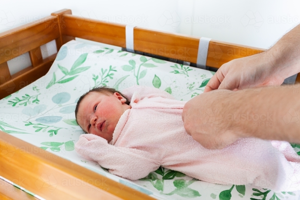 Newborn baby on change table getting a nappy change - Australian Stock Image