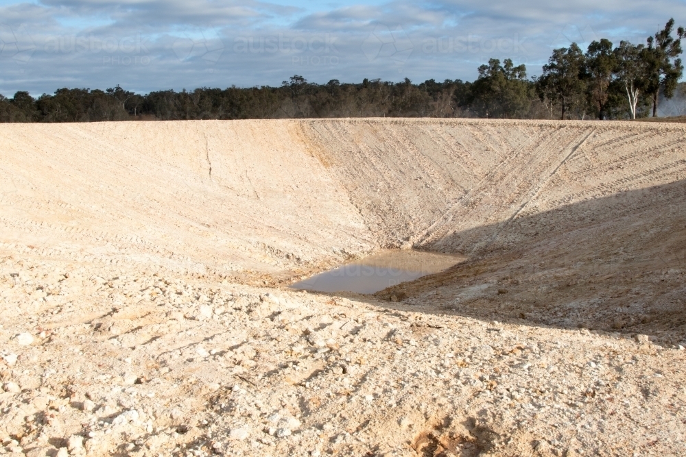 Newly constructed, nearly empty dam - Australian Stock Image