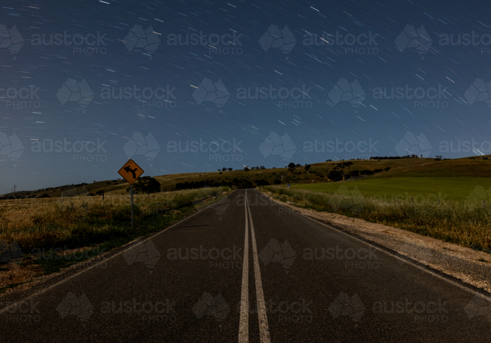 Image of Night sky and stars with road in foreground - Austockphoto