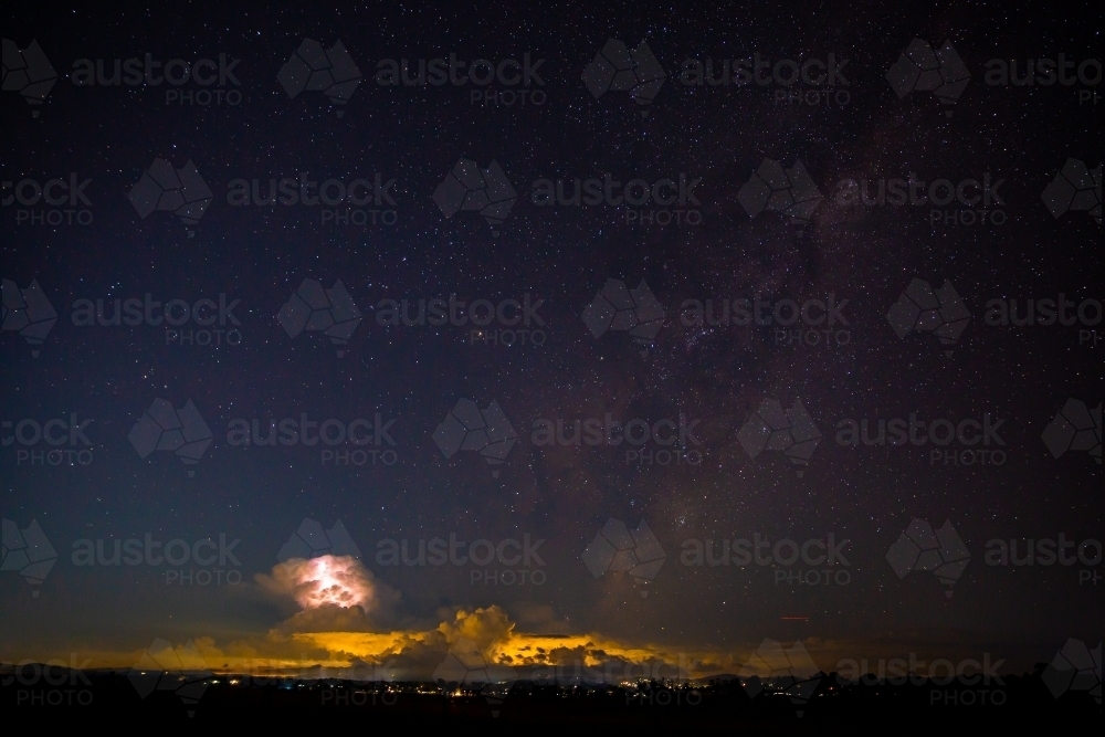 night sky stars with a distant thunderstorm - Australian Stock Image