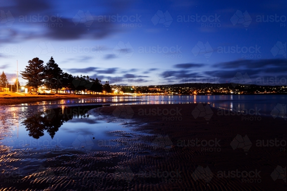 Night view of city lights and beach front - Australian Stock Image