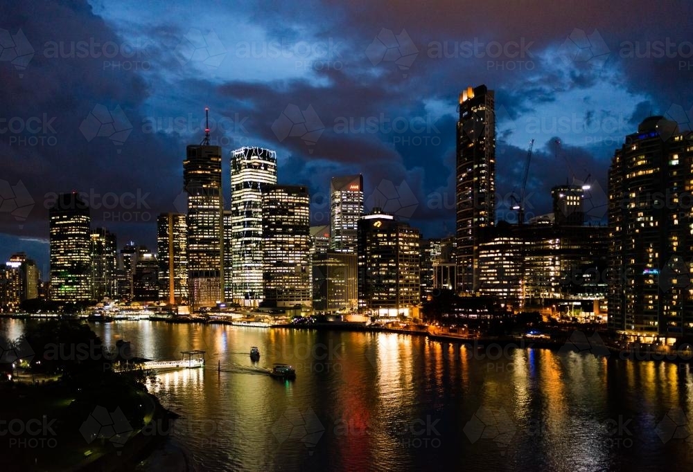 Night view of City skyline and lights reflected in the Brisbane River - Australian Stock Image