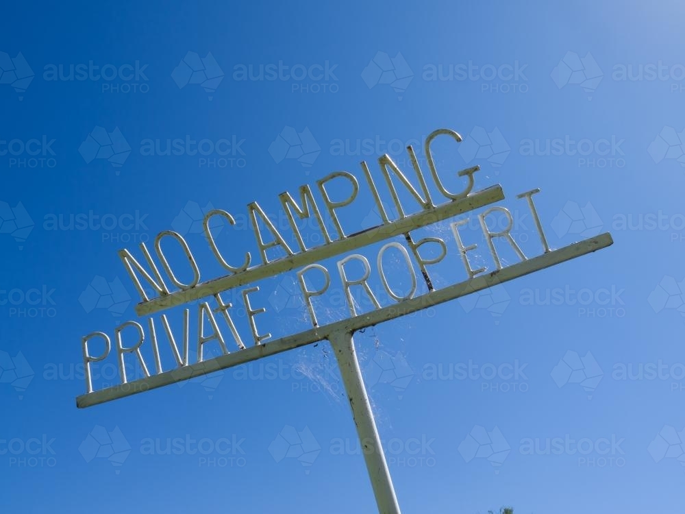 No Camping, Private Property metal sign against a blue sky - Australian Stock Image