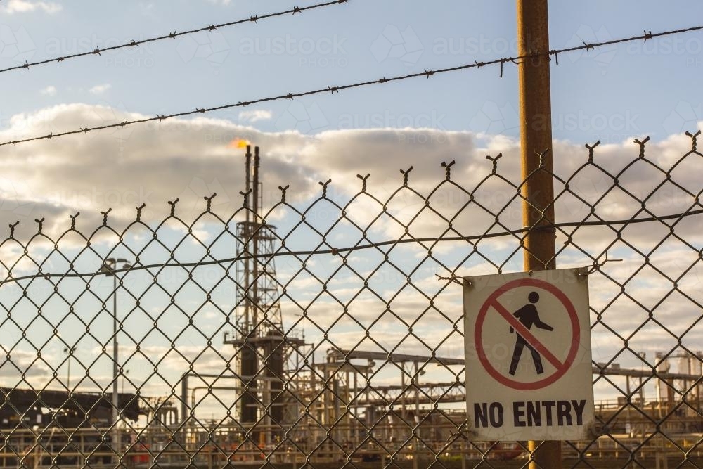 no entry fencing around a fuel refinery - Australian Stock Image