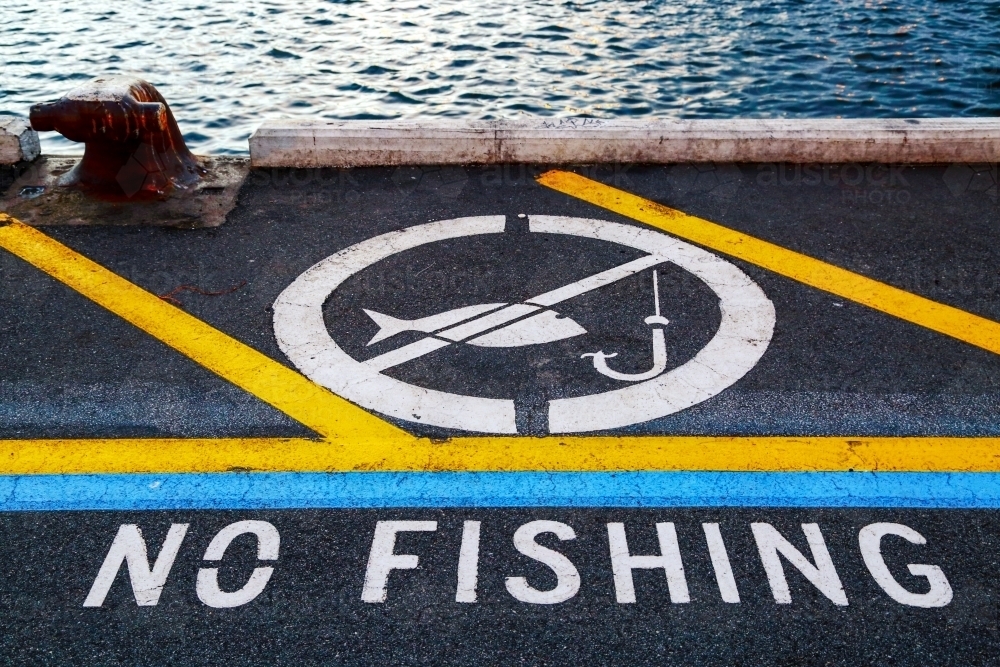 'No fishing' notification painted on a wharf - Australian Stock Image