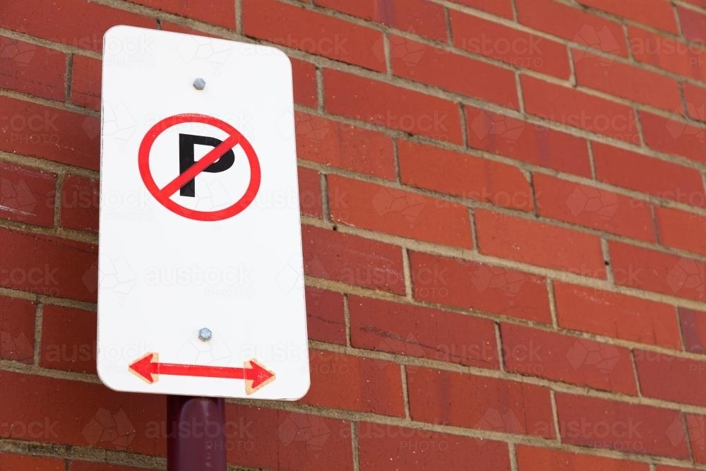 No parking sign against a brick wall - Australian Stock Image