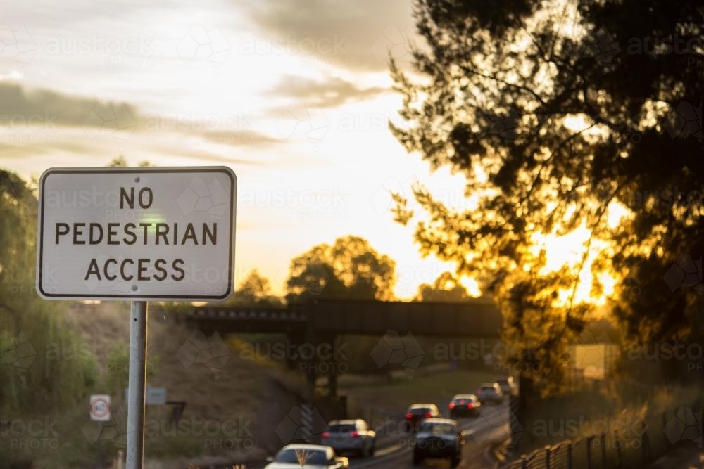 No pedestrian access road sign with bridge and cars in the background - Australian Stock Image