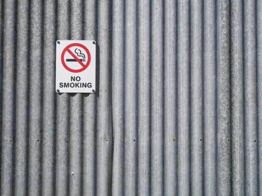 "NO SMOKING" sign on a corrugated iron wall - Australian Stock Image