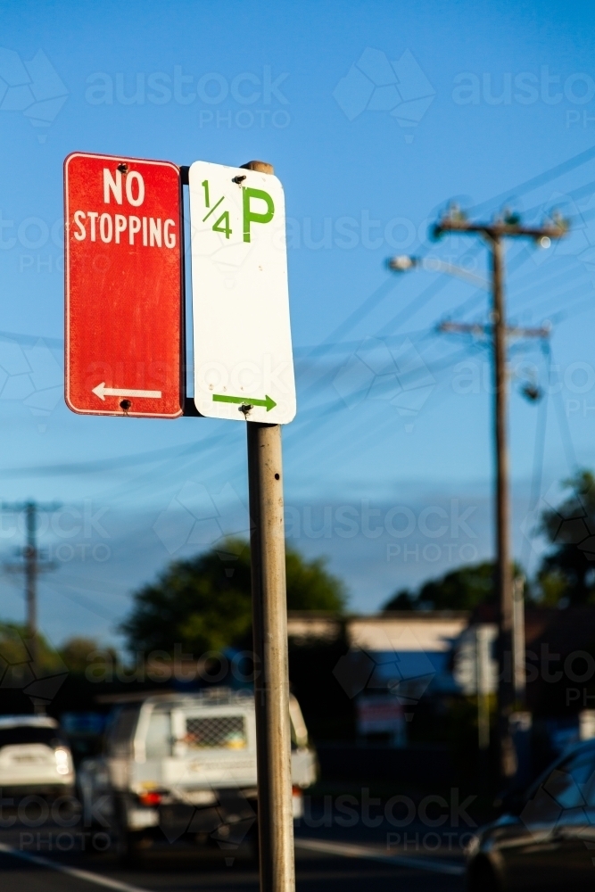 No stopping sign with arrow pointing one way and 1/4 hour parking sign the other way - Australian Stock Image