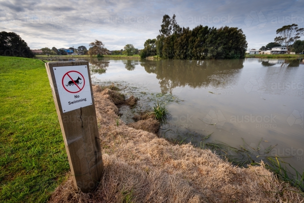 'No Swimming' sign beside a local lake - Australian Stock Image