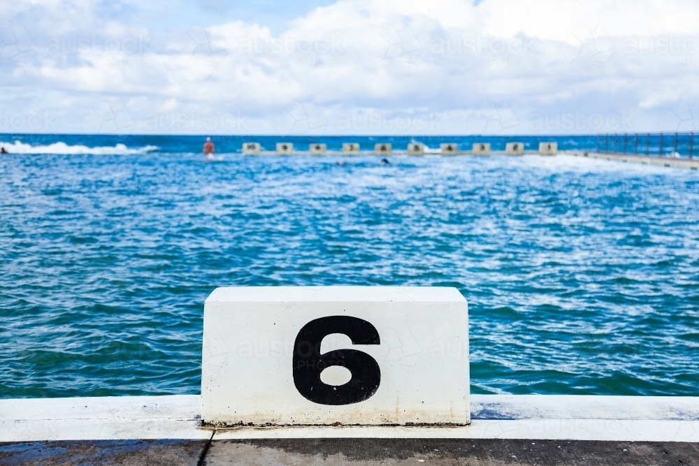Number 6 six swimming lane in ocean pool - Australian Stock Image
