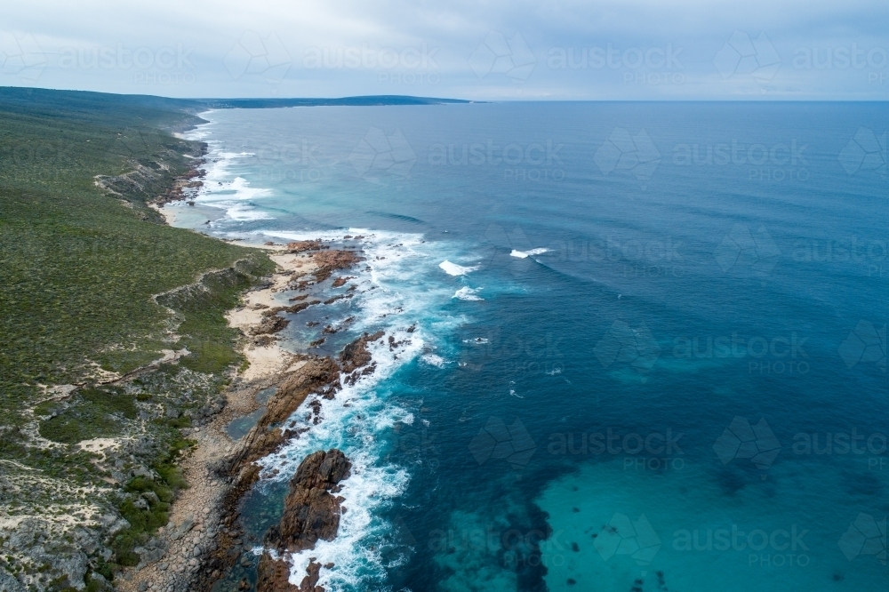Oblique aerial view of rugged coastline and ocean. - Australian Stock Image