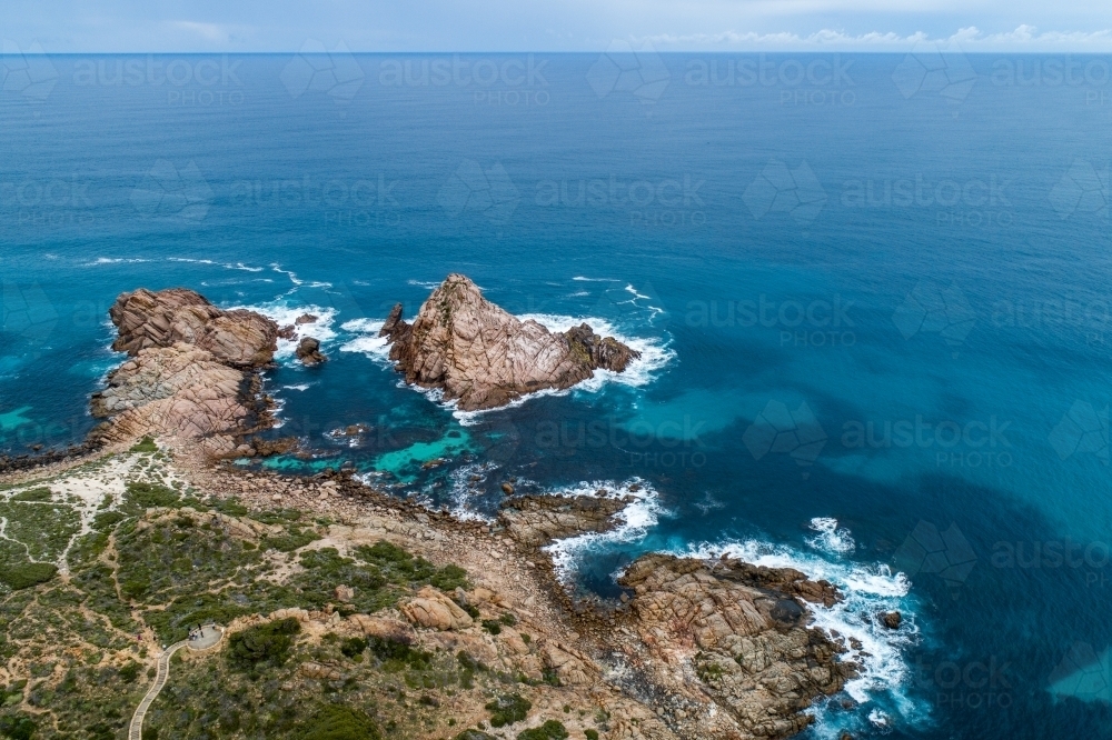Oblique aerial view of Sugarloaf Rock, coastline, and ocean. - Australian Stock Image