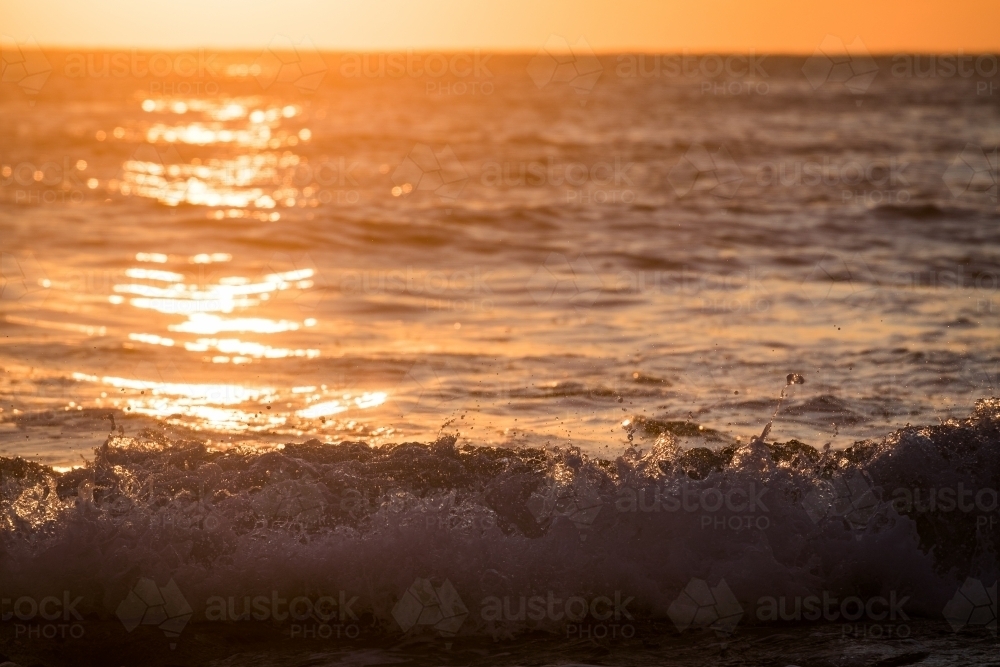ocean and waves at sunrise - Australian Stock Image