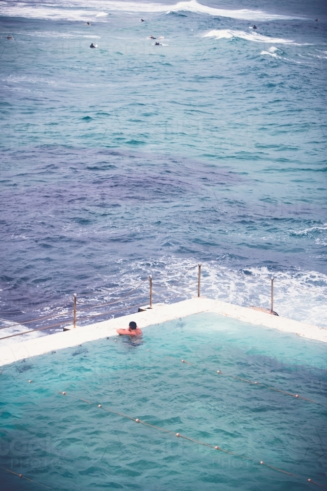 Ocean pool, swimmer watching the surfers - Australian Stock Image