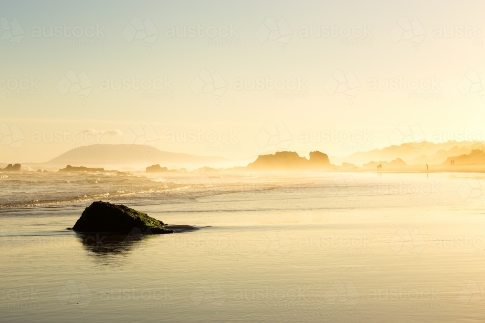 Ocean shoreline during a misty sunset - Australian Stock Image