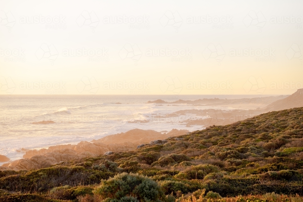 Ocean view of rugged coastline at sunset - Australian Stock Image