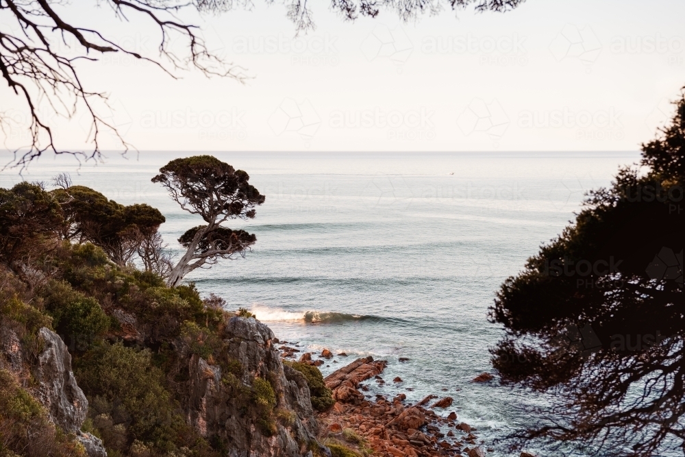 Ocean view of rugged coastline at sunset - Australian Stock Image