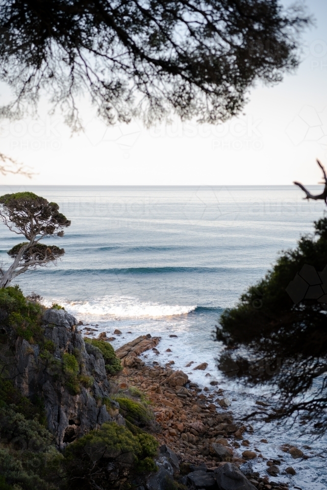 Ocean view of rugged coastline at sunset - Australian Stock Image