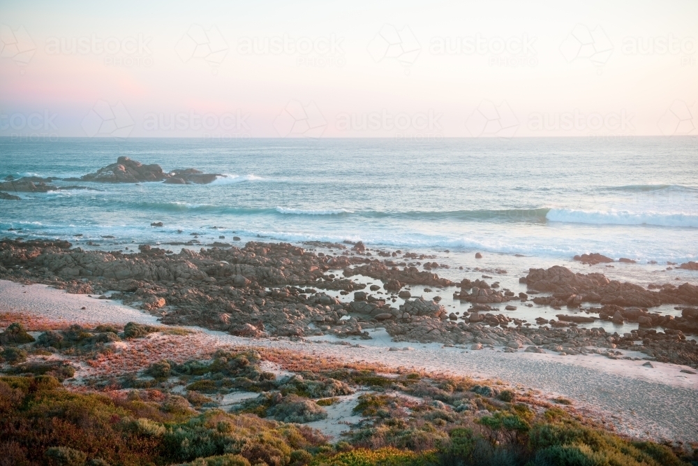 Ocean view of rugged coastline at sunset - Australian Stock Image
